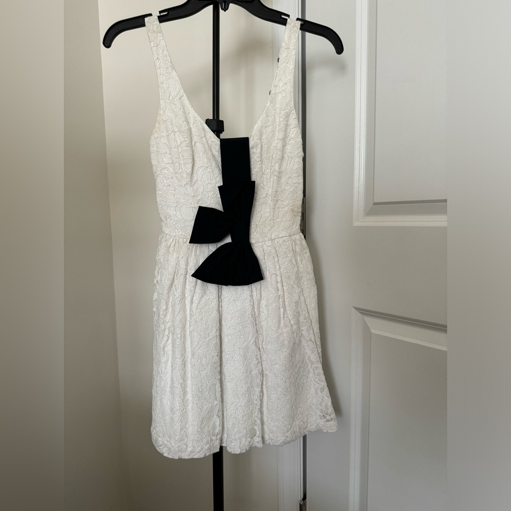 White lace dress with navy bow belt
